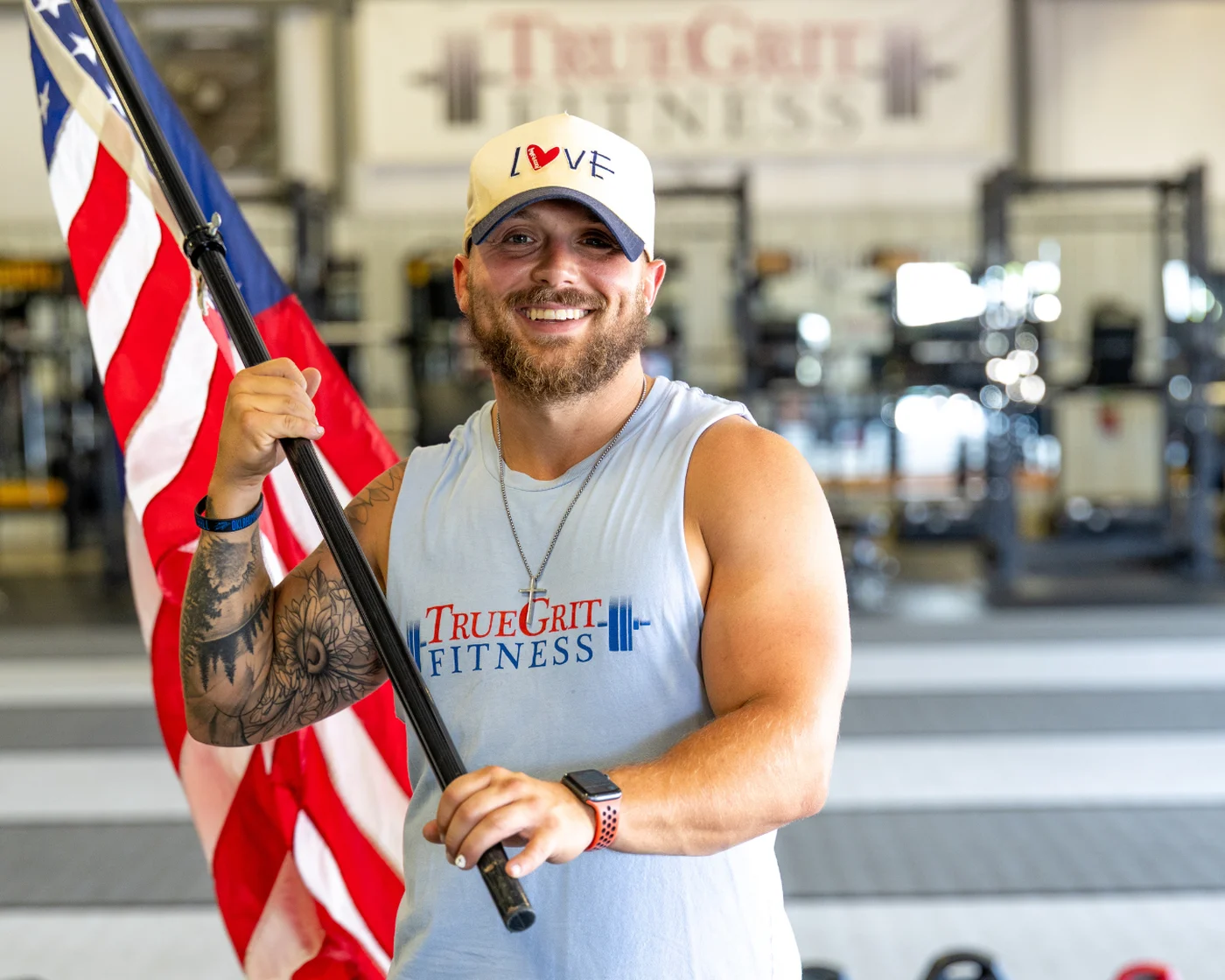 True Grit Fitness member holding an American flag before the Memorial Day Murph workout in Oklahoma City