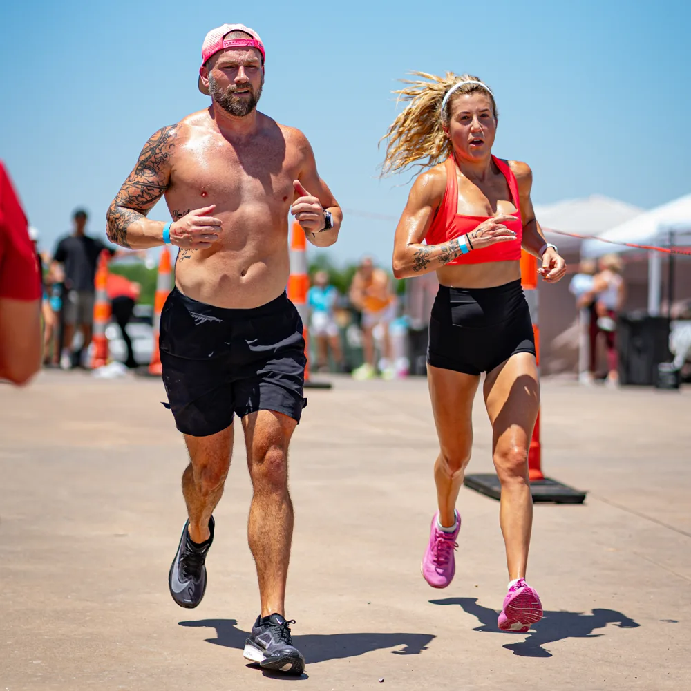 Two Hyrox Sprint competitors running the outdoor run segment in Oklahoma City