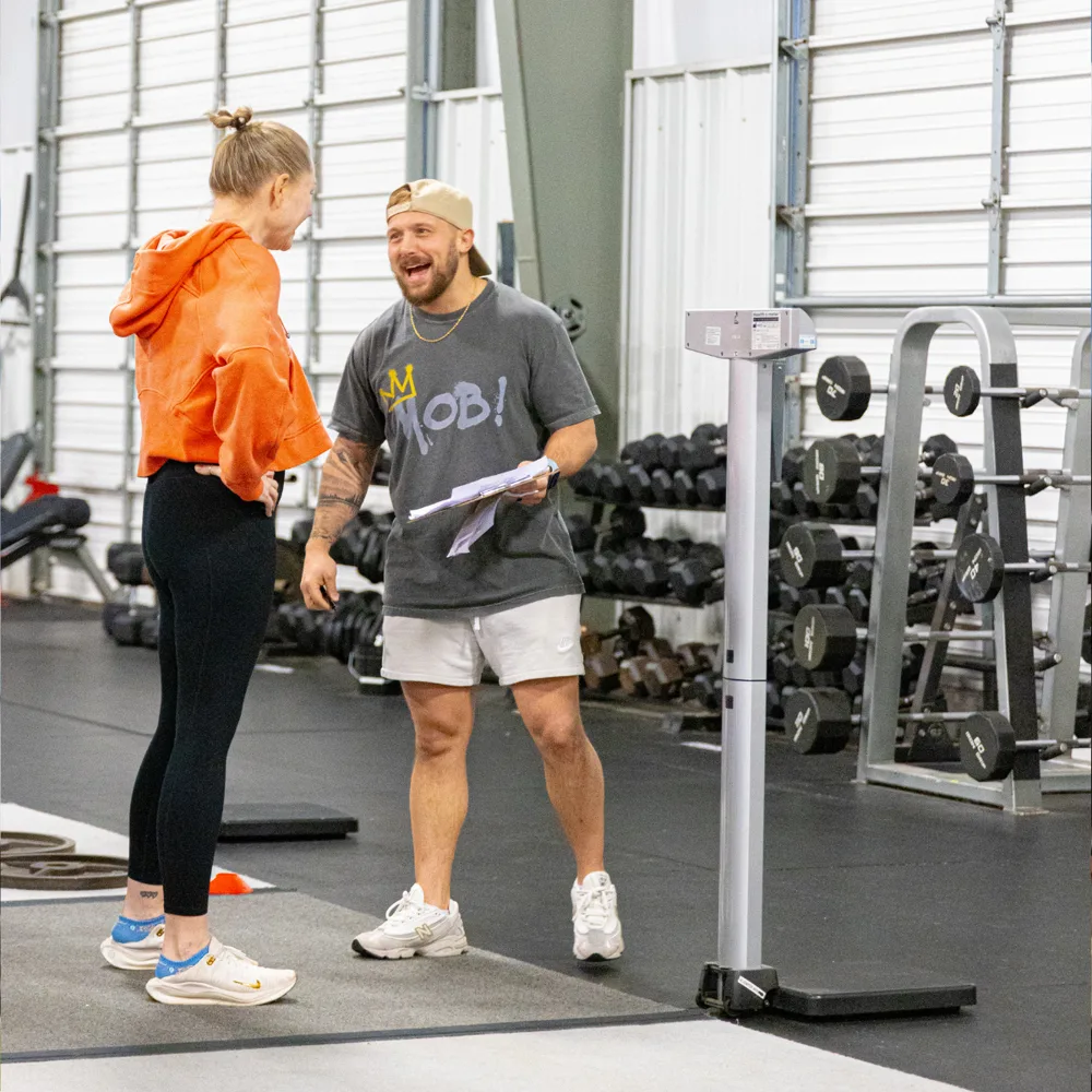 True Grit Fitness coach taking a personal training client's progress check-in measurements