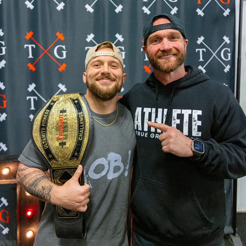 Ultimate Grit Challenge belt winner with owner Travis Grimm at True Grit Fitness