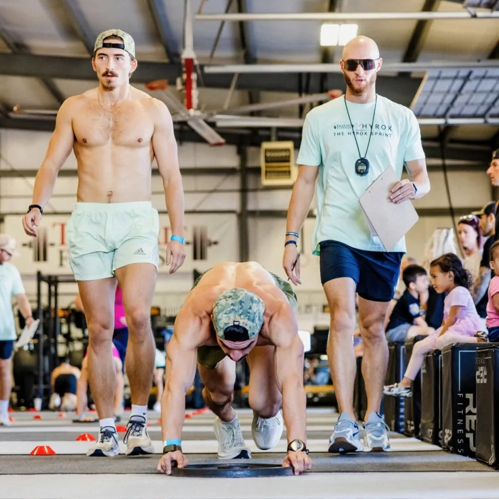 Judge counting burpee broad jumps during the Hyrox Sprint at True Grit Fitness